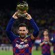 Lionel Messi shows his sixth Ballon d'Or to fans at the Camp Nou stadium in Barcelona in December last year