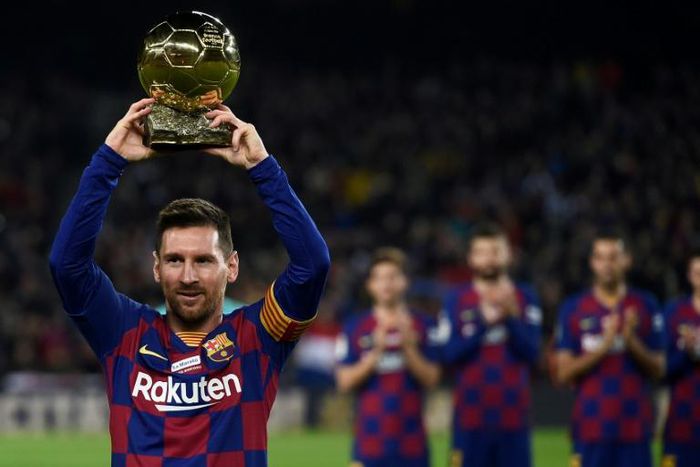 Lionel Messi shows his sixth Ballon d'Or to fans at the Camp Nou stadium in Barcelona in December last year