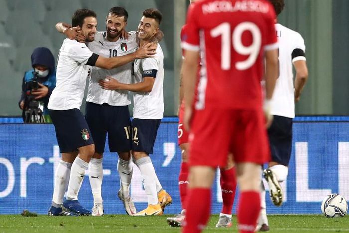 Veteran Francesco Caputo (C) celebrates after scoring on his Italy debut in Florence.