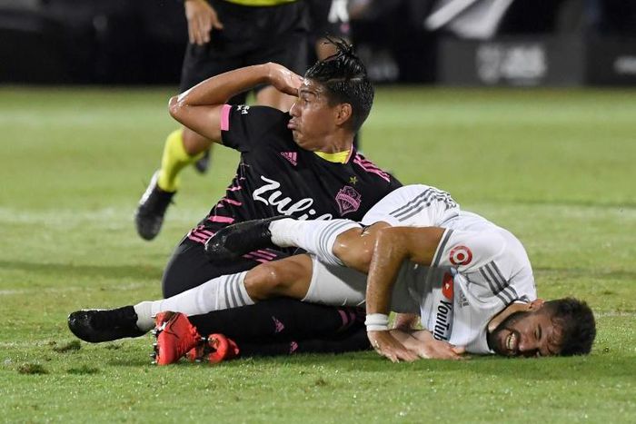Los Angeles FC star Diego Rossi (white) is fouled by Seattle defender Xavier Arreaga which resulted in a penalty goal as the LAFC advanced to the quareter-finals with a 4-1 win over the reigning MLS champions in Florida