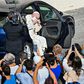 Pope Francis quickly removed his face mask as he emerged from his car