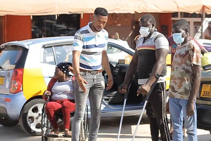 Ghanaian policeman gives to the physically challenged