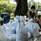 A woman prepares sand bags for the residents of Palmetto Bay near Miami as Florida prepares for the impact of Isaias