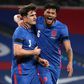 England defender Harry Maguire (L) celebrates with Tyrone Mings