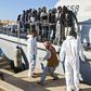 Migrants disembark in October 2019 from a Libyan coast guard ship in the town of Khoms, part of the instability that has led the United States to impose sanctions on smugglers