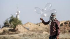 Palestinian militants have been using improvised balloons to carry incendiary materials across the Gaza border into Israel, which imposes a tight blockade on the enclave