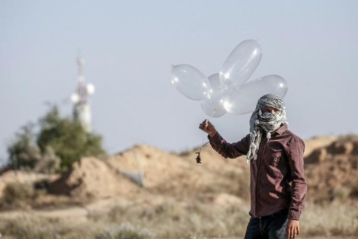 Palestinian militants have been using improvised balloons to carry incendiary materials across the Gaza border into Israel, which imposes a tight blockade on the enclave