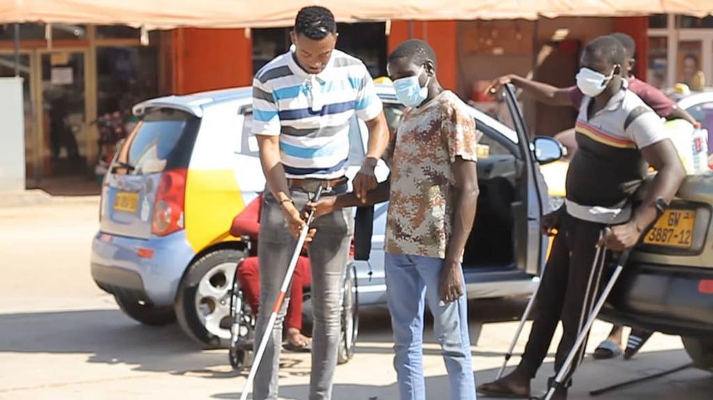 Ghanaian policeman gives to the physically challenged