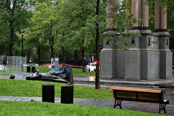 A statue of the first Canadian Prime Minister John A. Macdonald lies on the ground, with the statue's head a few meters away, at Canada Park in central Montreal on August 29, 2020, after it was pulled down by anti-racism protesters during a demonstrati...