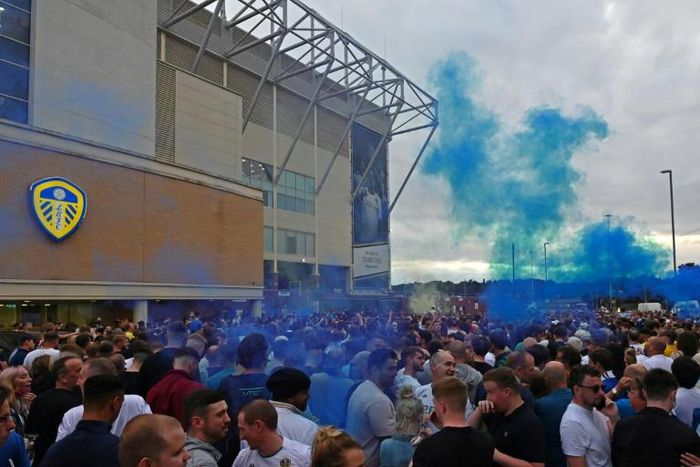 Leeds United supporters gather outside their Elland Road ground to celebrate promotion