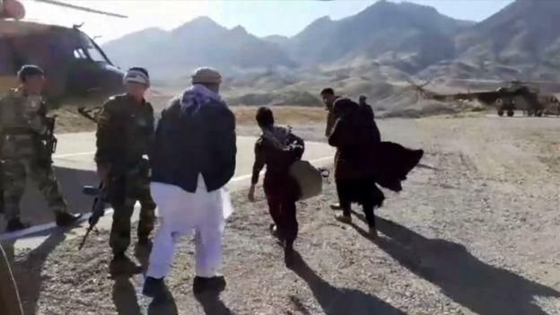 Nooria and her two brothers boarding a military helicopter