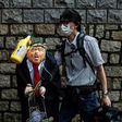 A pro-China activist holds an effigy of President Donald Trump outside the US consulate in Hong Kong in May 2020 after he announced restrictions on Chinese students