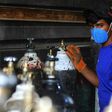 A worker refills oxygen cylinders at a factory in Taji district north of Iraq's capital Baghdad, before delivering them to hospitals amid the COVID-19 pandemic