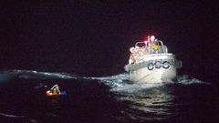Dramatic photos released by Japan's coast guard showed the rescue of one survivor from a ship that sank during a typhoon