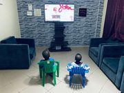 Grandsons of Prof Opoku-Agyemang watching her deliver her speech [Facebook]