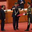 Chinese President Xi Jinping (C) hands a medal to Zhong Nanshan (L) -- the country's most famous medical expert who emerged as the face of China's fight against Covid-19