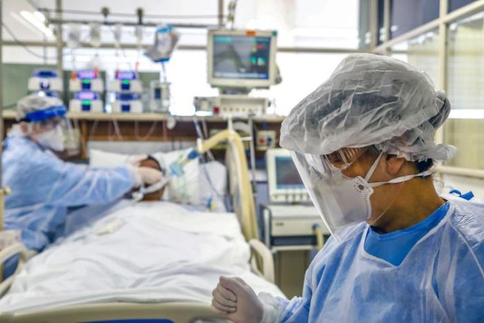 Doctors treat a patient infected with COVID-19, which has pushed the Brazilian health care system to the brink, at the Intensive Care Unit of the Hospital de Clinicas, in Porto Alegre, Brazil, on April 15, 2020