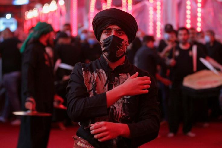 A Shiite Muslim worshipper commemorates the martyrdom of the Prophet Mohammad's grandson Imam Hussein at his shrine in the Iraqi city of Karbala