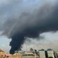 A huge column of black smoke billows into the sky over Beirut as the city's port is again engulfed by fire just weeks after a devastating dockside explosion