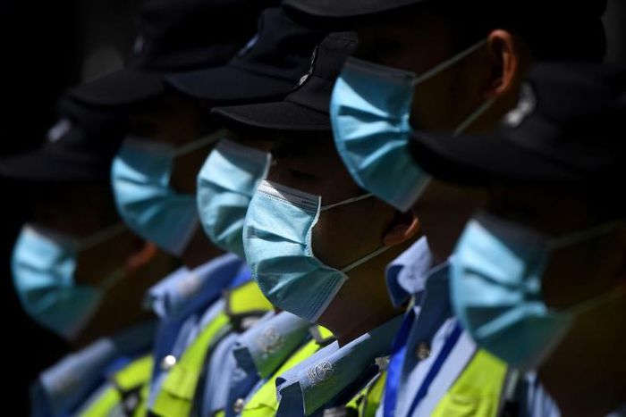 Masked police in front of the shuttered US consulate in Chengdu