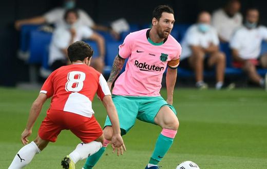 In the pink: Messi evaded Girona defenders to set up Barcelona's first goal and to score the second and third