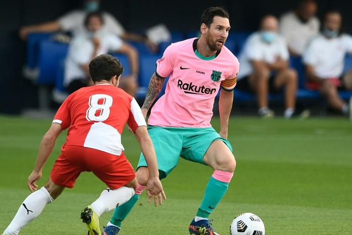 In the pink: Messi evaded Girona defenders to set up Barcelona's first goal and to score the second and third