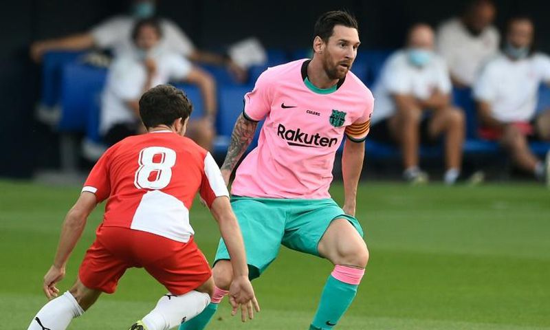In the pink: Messi evaded Girona defenders to set up Barcelona's first goal and to score the second and third