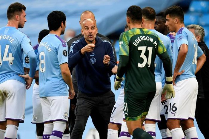 Pep Guardiola (centre) says he has to earn a new contract at Manchester City this season