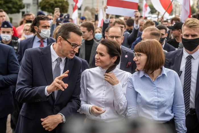 Exiled opposition leader Svetlana Tikhanovskaya walks with Polish Prime Minister Mateusz Morawiecki after telling Warsaw university students events in Belarus were 'historic'