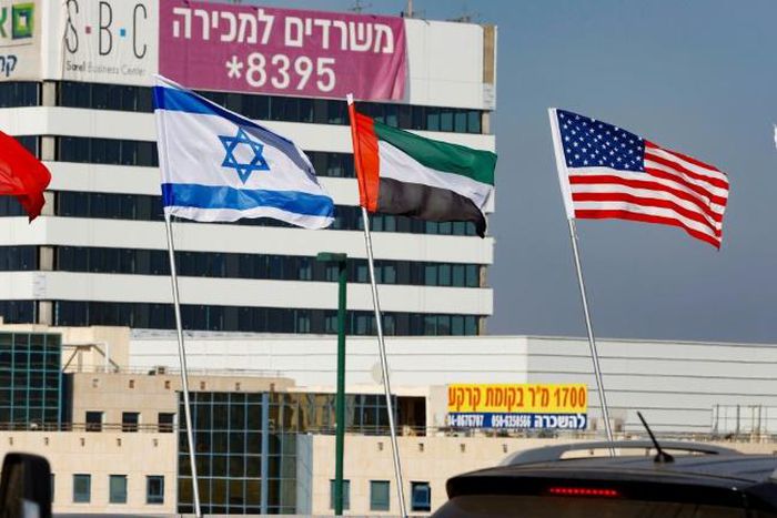 The national flags of (L-R) Bahrain, Israel, the United Arab Emirates, and the United States are flown along a road in Israeli resort city of Netanya after the two Gulf countries agreed to normalise ties with the Jewish state