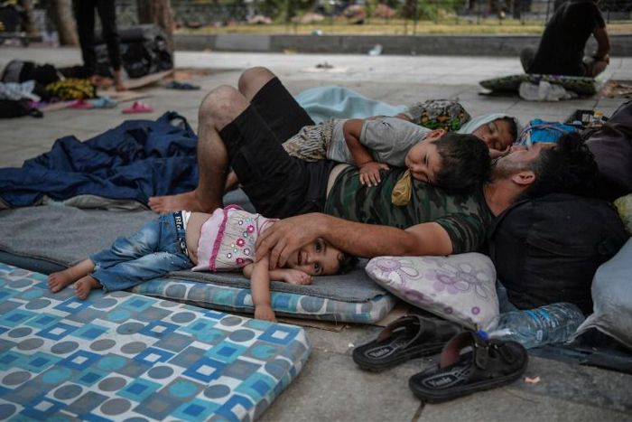 Around 100 mostly Afghan refugees have been camping in Athens under temperatures exceeding 30 degrees Celsius