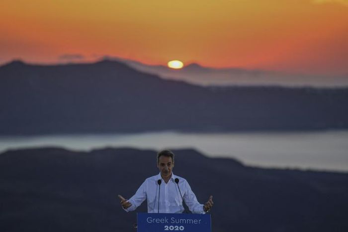 Greek Prime Minister Kyriakos Mitsotakis, seen visiting the island of Santorini, insists the Corfu project is good for the island and also respects the environment