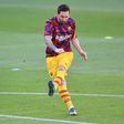 Lionel Messi warms up before Barcelona's friendly against Gimnastic Tarragona from the Spanish third tier