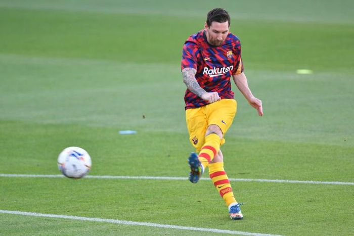 Lionel Messi warms up before Barcelona's friendly against Gimnastic Tarragona from the Spanish third tier