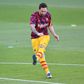 Lionel Messi warms up before Barcelona's friendly against Gimnastic Tarragona from the Spanish third tier