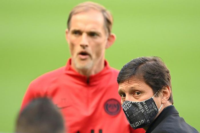 Paris Saint-Germain coach Thomas Tuchel stands behind the club's Brazilian sporting director Leonardo before their team's training session at the Stade de France on Thursday