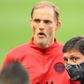 Paris Saint-Germain coach Thomas Tuchel stands behind the club's Brazilian sporting director Leonardo before their team's training session at the Stade de France on Thursday