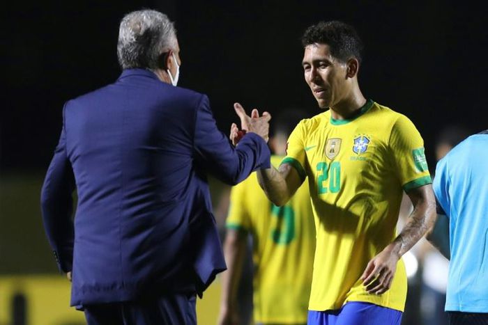 Brazil's coach Tite greets goal-scorer Roberto Firmino after defeating Venezuela 1-0 in their closed-door World Cup qualifier in Sao Paulo on Friday