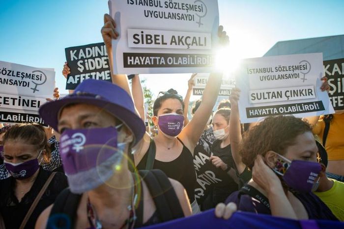 Demonstrators wearing protective face masks hold up placards during a demonstration for a better implementation of the Istanbul Convention and the Turkish Law 6284 for the protection of the family and prevention of violence against women, in Istanbul