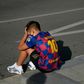 A boy wearing a Lionel Messi shirt waits for the Argentinian to arrive for coronavirus tests at Barcelona's training ground on Sunday.
