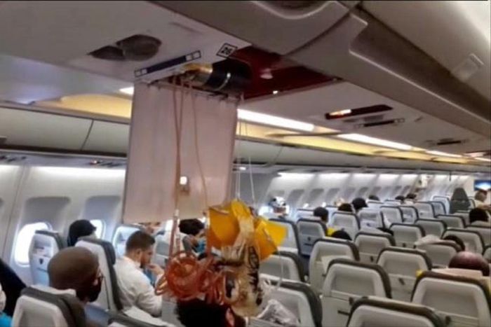 An oxygen mask dangles in the cabin of an Iranian passenger plane after it was intercepted by US jets while flying over Syria