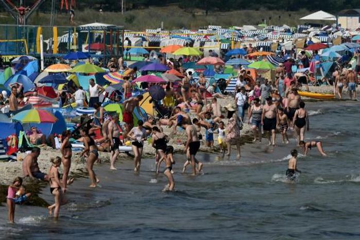 Despite COVID-19 fears, people enjoy warm summer weather at a beach near the Baltic Sea village of Binz, northern Germany
