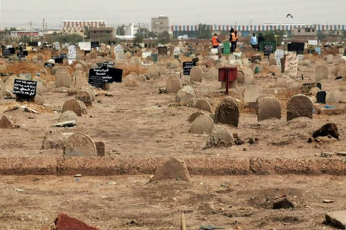 Members of a forensic team at a first mass grave found south of Khartoum in June
