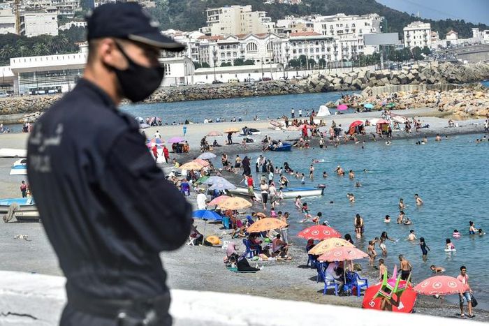 Algerians throng a beach in the Bab el-Oued suburb of the capital Algiers after authorities reopened beaches for the first time following a five-month coronavirus lockdown