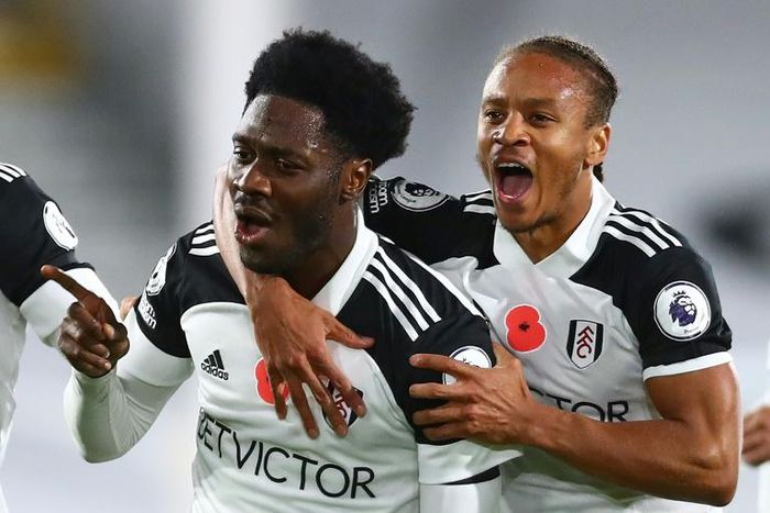 Fulham's Ola Aina (L) celebrates scoring against West Brom