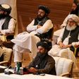 Taliban co-founder Mullah Abdul Ghani Baradar (R, bottom) speaks during the opening session of peace talks with the Afghan government