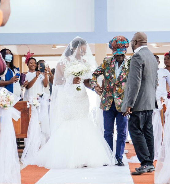 Efya being walked down the aisle by musician Kojo Antwi