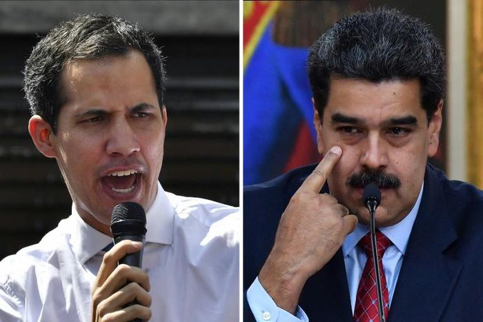 Venezuelan President Nicolas Maduro (R) has pardoned more than 100 lawmakers and associates of opposition leader Juan Guaido