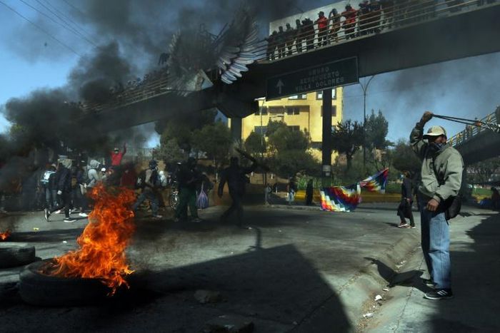 Supporters of Bolivia's exiled ex-president Evo Morales blocking a road in protest at the latest delay to the general election originally due in May, 2020