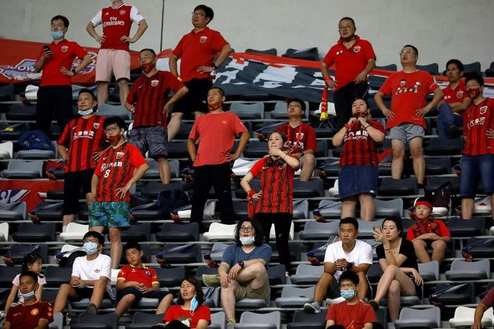 Shanghai SIPG fans watch their side's match against Beijing Guoan in Suzhou, while keeping a social distance